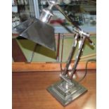 An Art Deco style nickel plated adjustable desk lamp on square stepped foot.