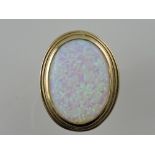 A large opalescent dress ring, set within a stepped frame, on a yellow metal band stamped 375, 13g.