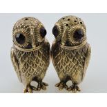 A pair of gilt metal owl-shape condiments, with faceted red eyes, stamped 800 to the bases, H. 6.