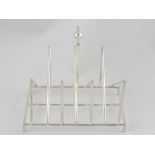 A white metal six division toast rack, in the manner of Christopher Dresser,