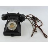 A black Bakelite 312L Call Exchange GPO telephone, circa 1956.