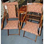 Two similar Edwardian stained walnut folding chairs, with upholstered pad backs and seats.