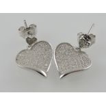 A pair of white metal and cubic zirconia heart-shaped earrings,