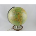 A 1950s JRO illuminated terrestrial globe on nickel mounted dished wood stand.