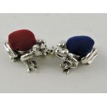 A pair of white metal pin cushions cast in the form of frogs, each stamped 925.