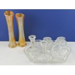 A seven-piece glass dressing table set, together with a pair of amber carnival glass vases.
