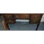 A 1920s mahogany kneehole dressing table, fitted five drawers on square legs, W. 114cm.
