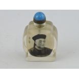 A clear glass snuff bottle reverse painted with a figure of a gentleman and character marks, H. 7cm.