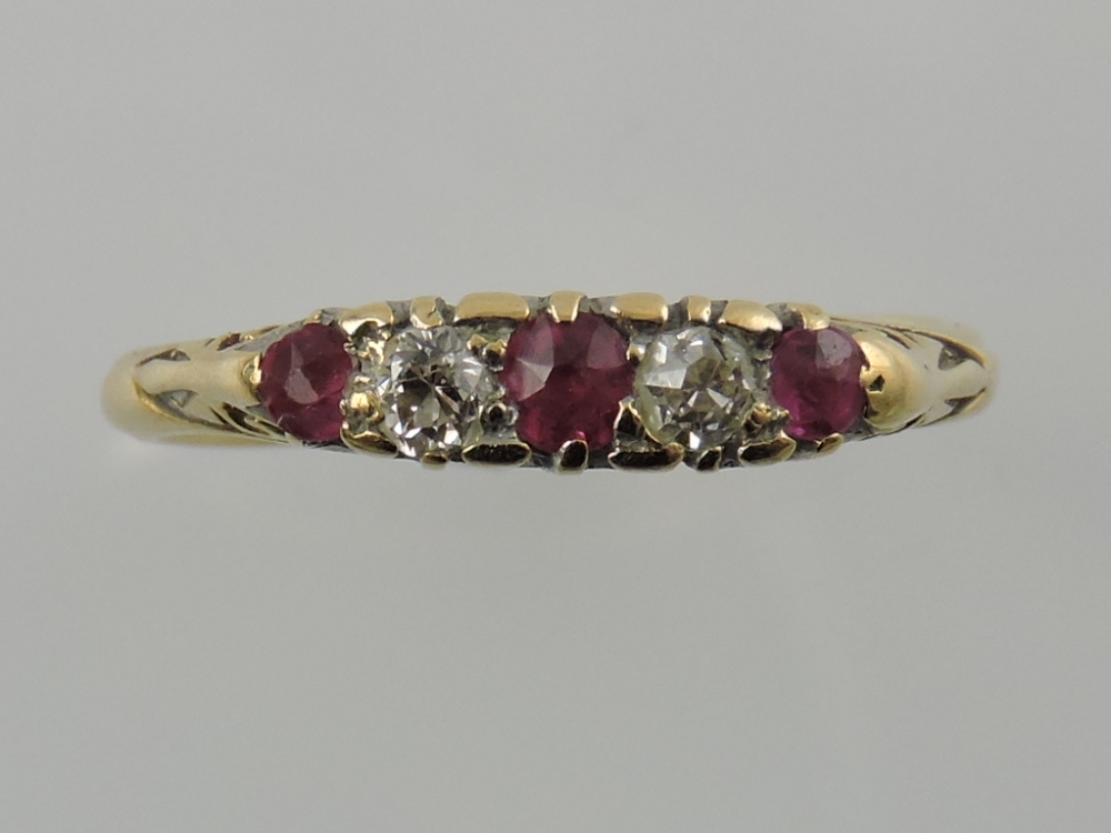 A five-stone diamond and ruby dress ring, with filigree mount, and yellow metal and stamped 18ct,