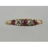 A five-stone diamond and ruby dress ring, with filigree mount, and yellow metal and stamped 18ct,
