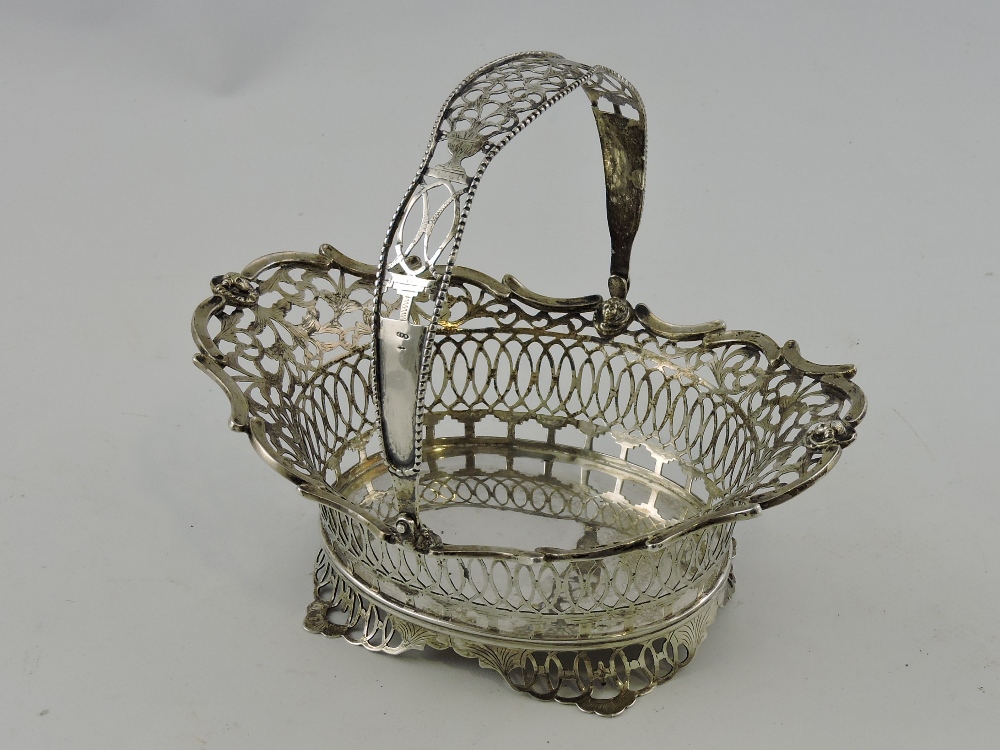 A Dutch white metal pierced oval basket, circa 1922, with swing handle, 7ozt.