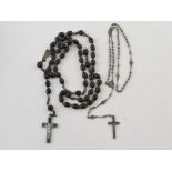 A crucifix on a bead necklace, together with another similar on a bead necklace.