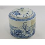 A blue and white lidded jar, decorated with a scholar in a landscape, H. 15cm.