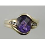 An amethyst and diamond set dress ring, set in a yellow metal band stamped 375, 5g.