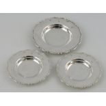 A silver armada dish, Sheffield 1997, with ogee shaped edge, together with two similar smaller,