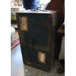 A vintage metal bound steamer trunk.