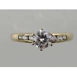 A cubic zirconia dress ring, the central claw set stone flanked by six further stones,