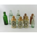 Nine various glass and salt glazed bottles including Gordon Jones Ltd Twickenham and Brentford,