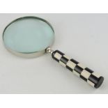 A table magnifier, with chequerboard handle, lens D. 10cm.