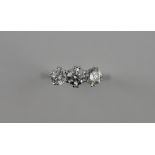 An 18ct white gold three stone diamond ring, total 1.