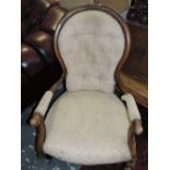 A Victorian style upholstered beech spoon back arm chair