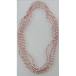 A very long string of pink freshwater pearls, L. 254cm.