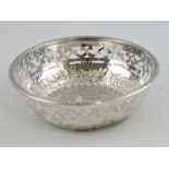 A white metal circular bowl, with pierced band and foliate repoussé decoration, 3ozt.