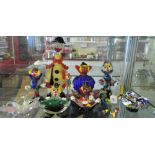 A collection of eight Murano/ Murano style glass clowns including a lemon spotted decanter,