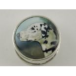 A circular white metal pill box, the hinged lid bearing the image of a dalmatian and stamped 925.