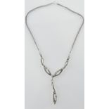 A white metal and marcasite necklace, with drop and  integral chain.