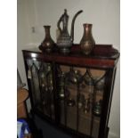 A 1920s mahogany bowfront display cabinet.