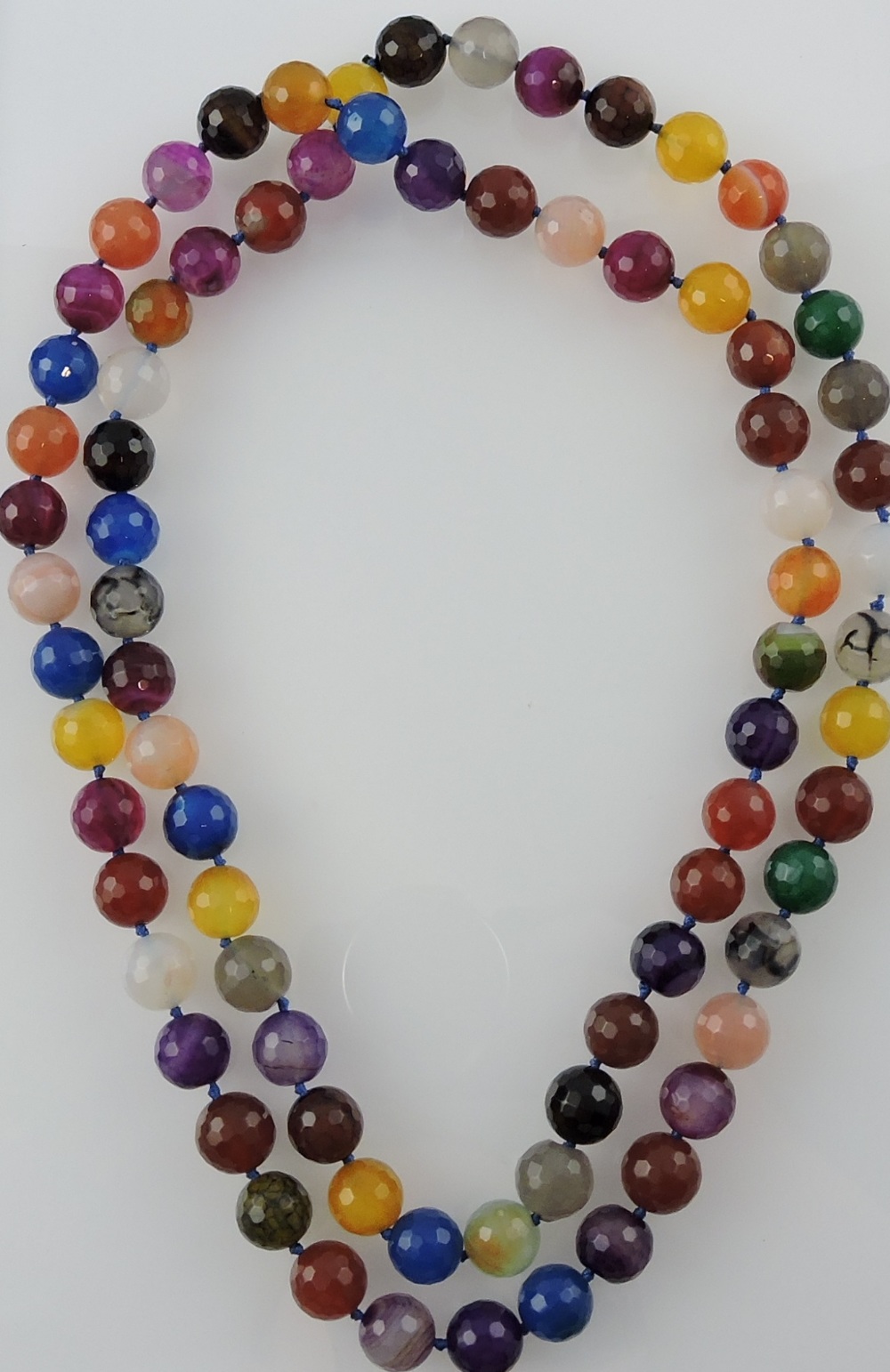 A string of stained hardstone faceted beads, L. 116cm.