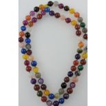 A string of stained hardstone faceted beads, L. 116cm.