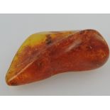 An amber deposit, of asymmetrical form, with inclusions.