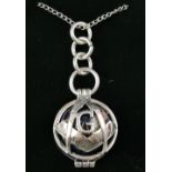 A white metal ball pendant, the Masonic themed frame enclosing a globe, marked 925,