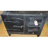 A painted wood two door cabinet modelled as a Victorian cast iron range, W. 97cm.