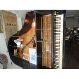 An unusual bespoke made open bookcase, constructed from a late 19th century ebonised grand piano,