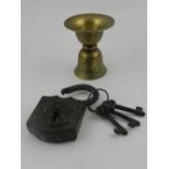 An 19th century Indian brass spit cup, together with a iron lock.