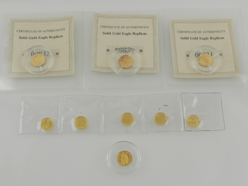 A collection of nine reproduction gold coins.