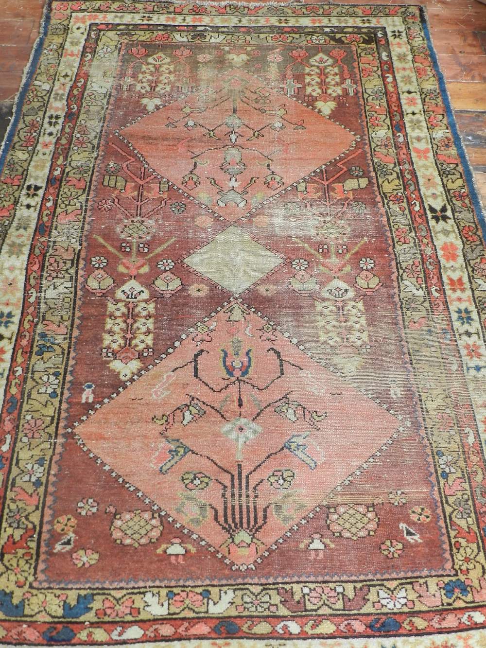 A Caucasian red ground rug, having three pole medallion to centre on a geometric ground,