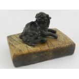 A Chinese bronze figure of a dog of Fo, set on a wooden base.