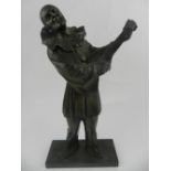 A patinated base metal sculpture of a figural study of a pierrot. H.
