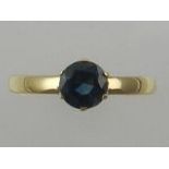 A Contemporary yellow metal posy ring, set with a brilliant cut sapphire (?),