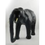In the style of Liberty, two leather upholstered studies of elephants, fitted resin horns,