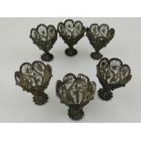 A set of six 18th century filigree silver stands, having pierced scrolling design.H.6cm