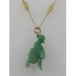 An unusual carved white and green jadeite pendant, fashioned as an exotic bird,