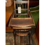 An Edwardian oak child's high chair.