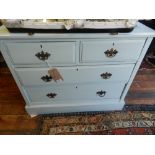 A blue painted chest of drawers, having two short over two long drawers,