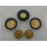 A collection of five gold coins, including a 1930 sovereign, an 1883 sovereign, a 1982 sovereign,