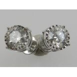 A pair of 18 carat white gold and diamond solitaire ear studs, the stones of approx. 2.6 carats